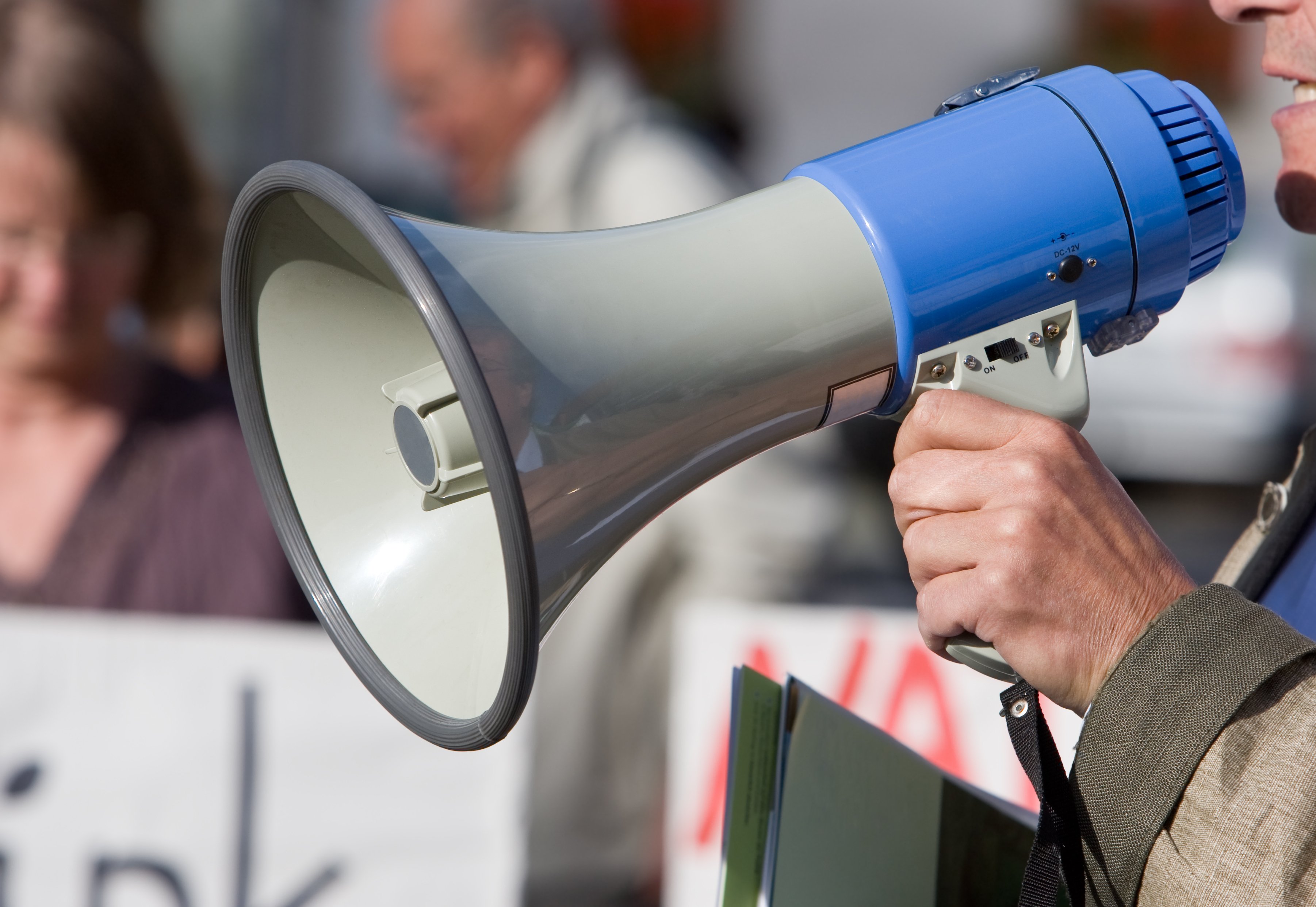 Person using a megaphone at a demonstration.