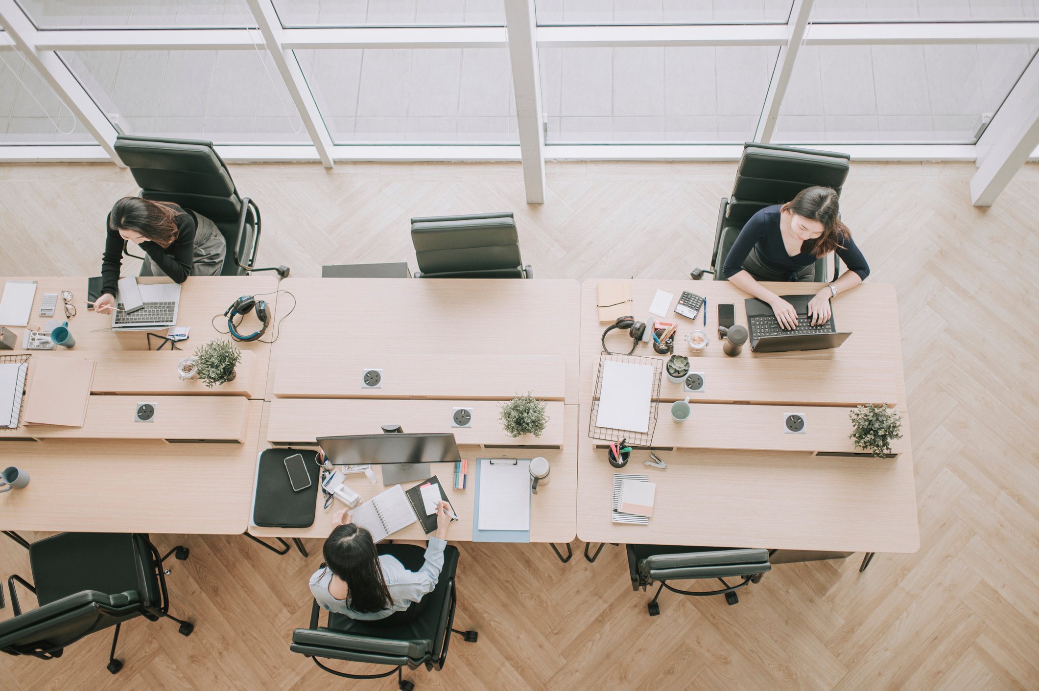 People working at a shared desk.