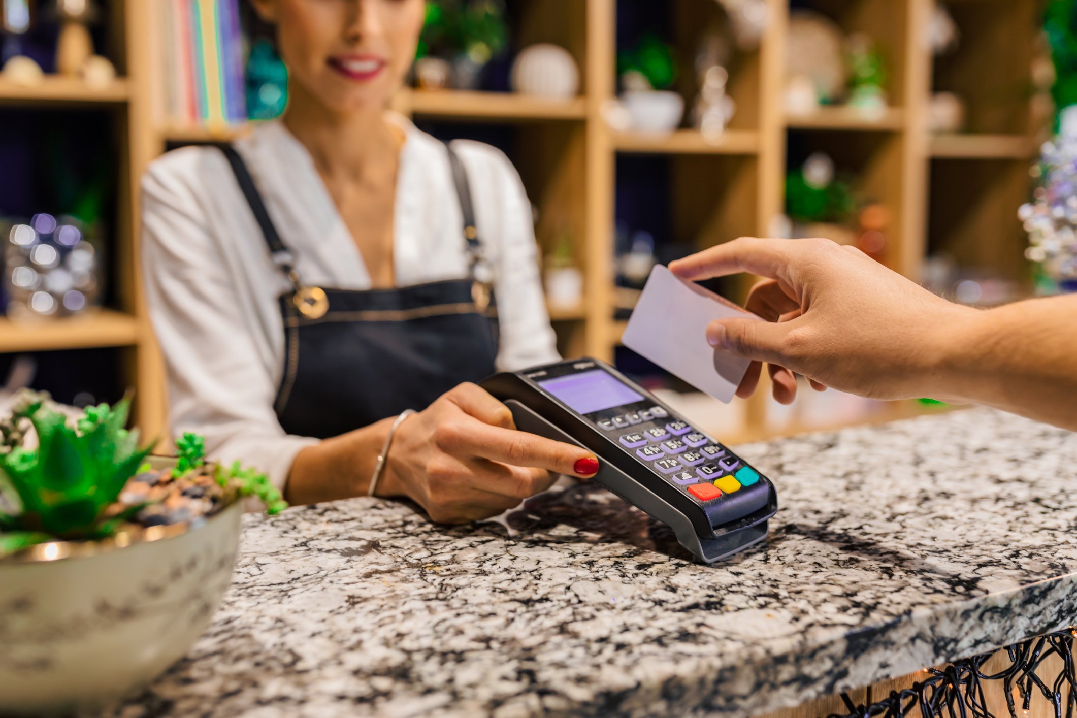 Person swiping a payment card.