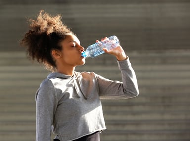 A person drinking from a water bottle