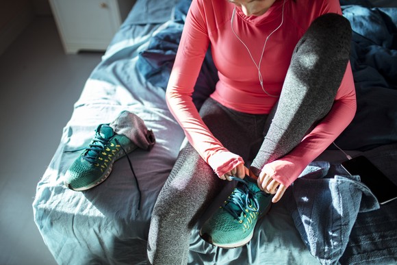 A person putting on athletic shoes.