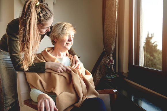 An Alzheimer's patient is attended to by a family member.