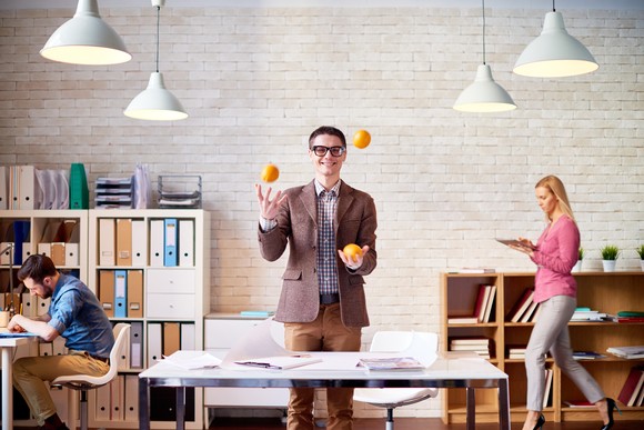 Happy person juggling oranges.