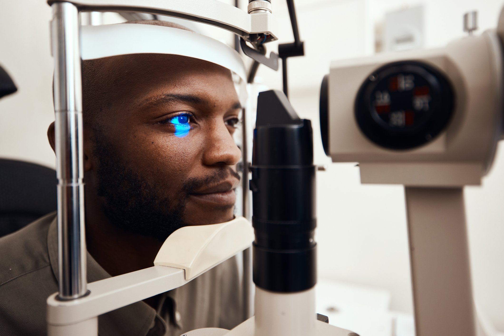 A person looking into an eye exam device.