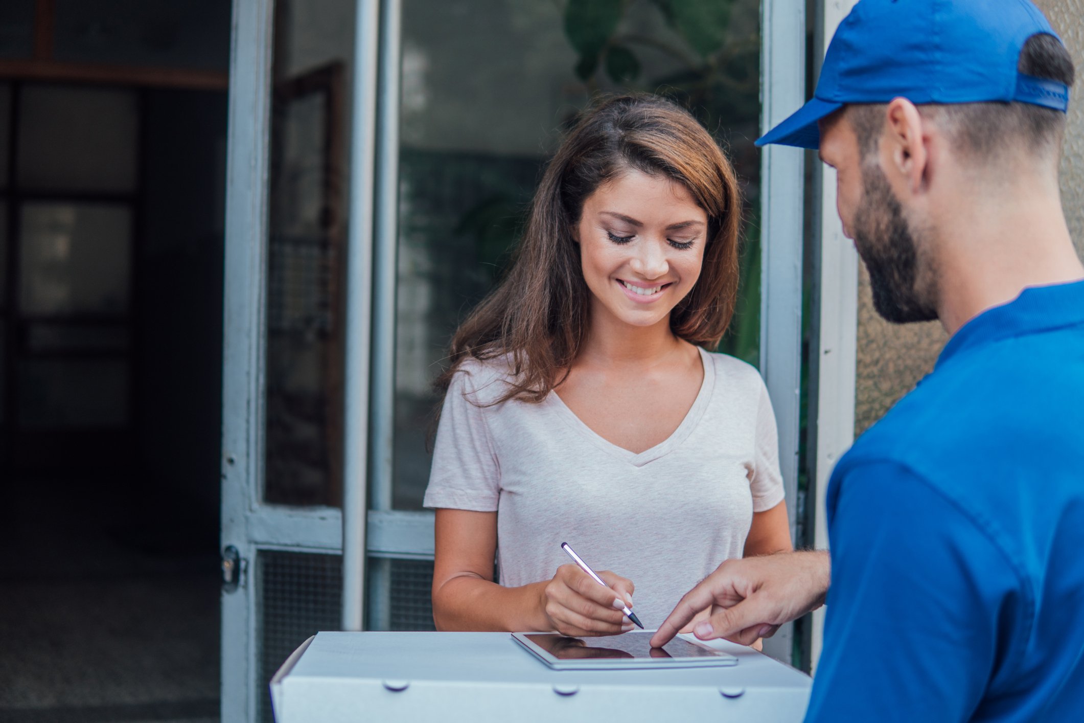 A person signing an electronic tablet.