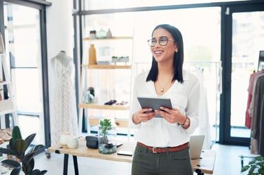 Woman in clothing shop with tablet