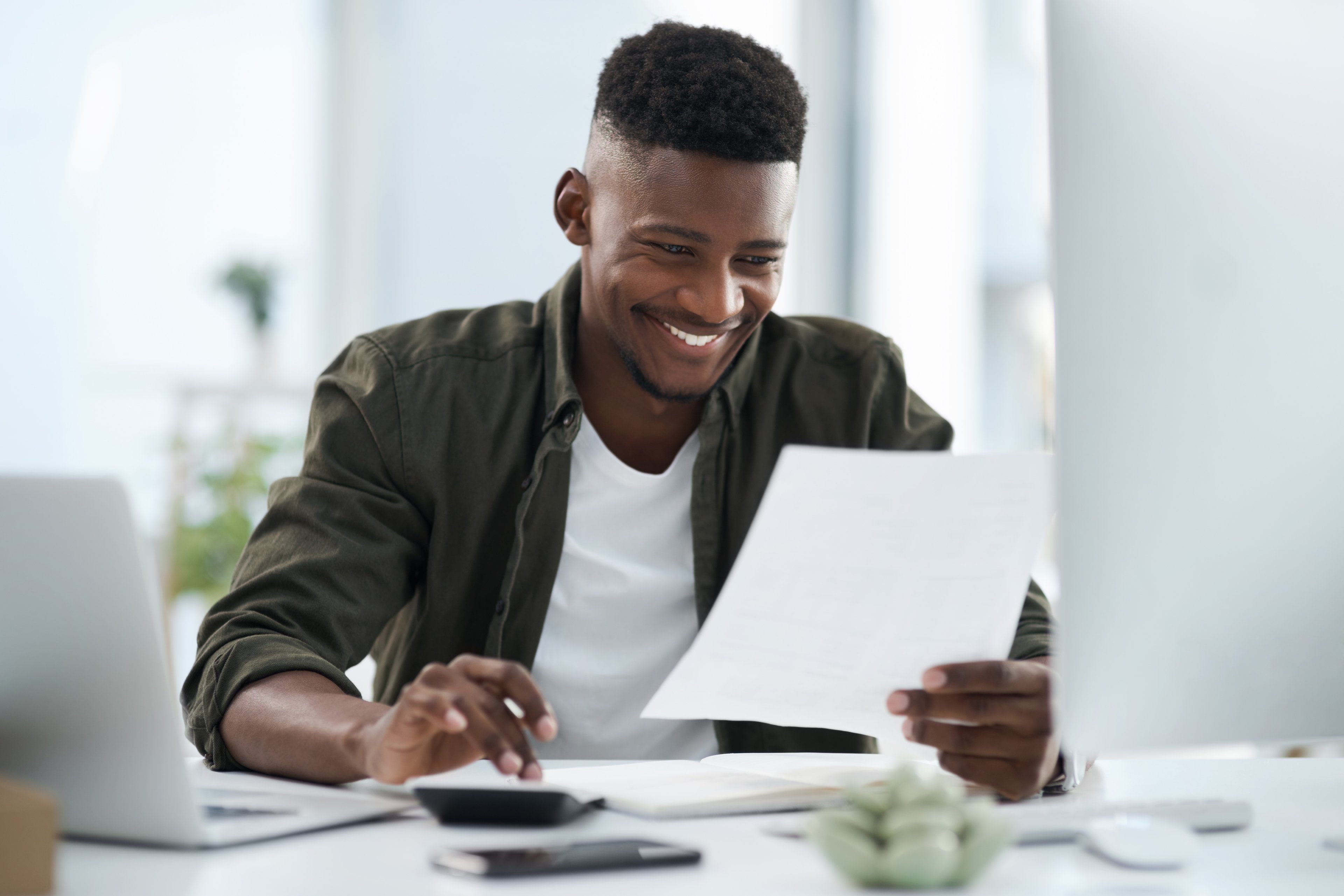 A person looking at a paper and smiling.