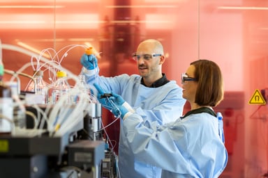 lab workers work on equipment