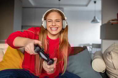person smiling while playing a video game