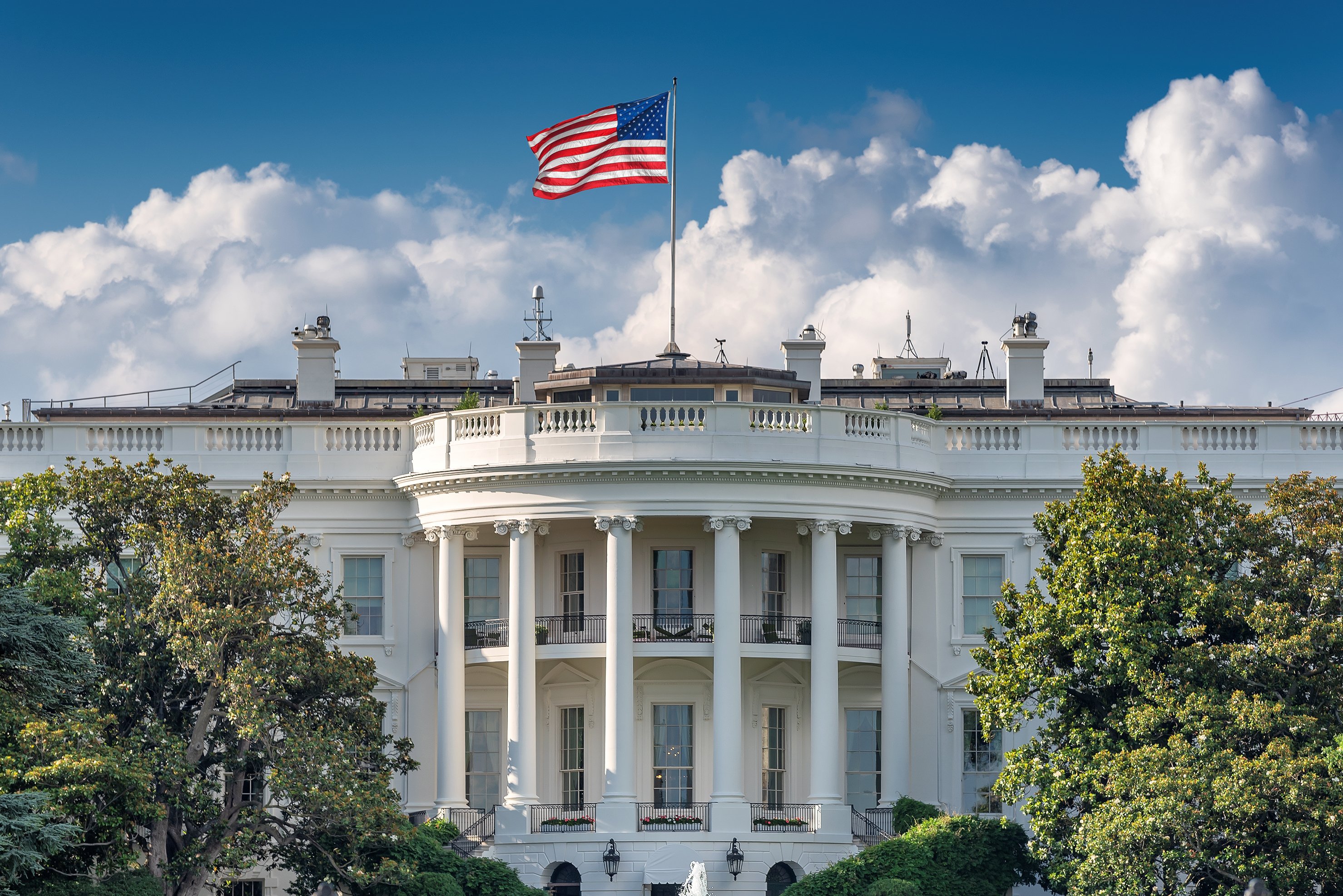A flag flies over the White House.