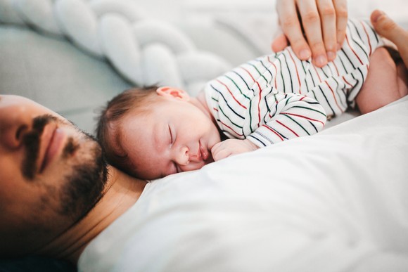 Baby sleeping on a person's chest.