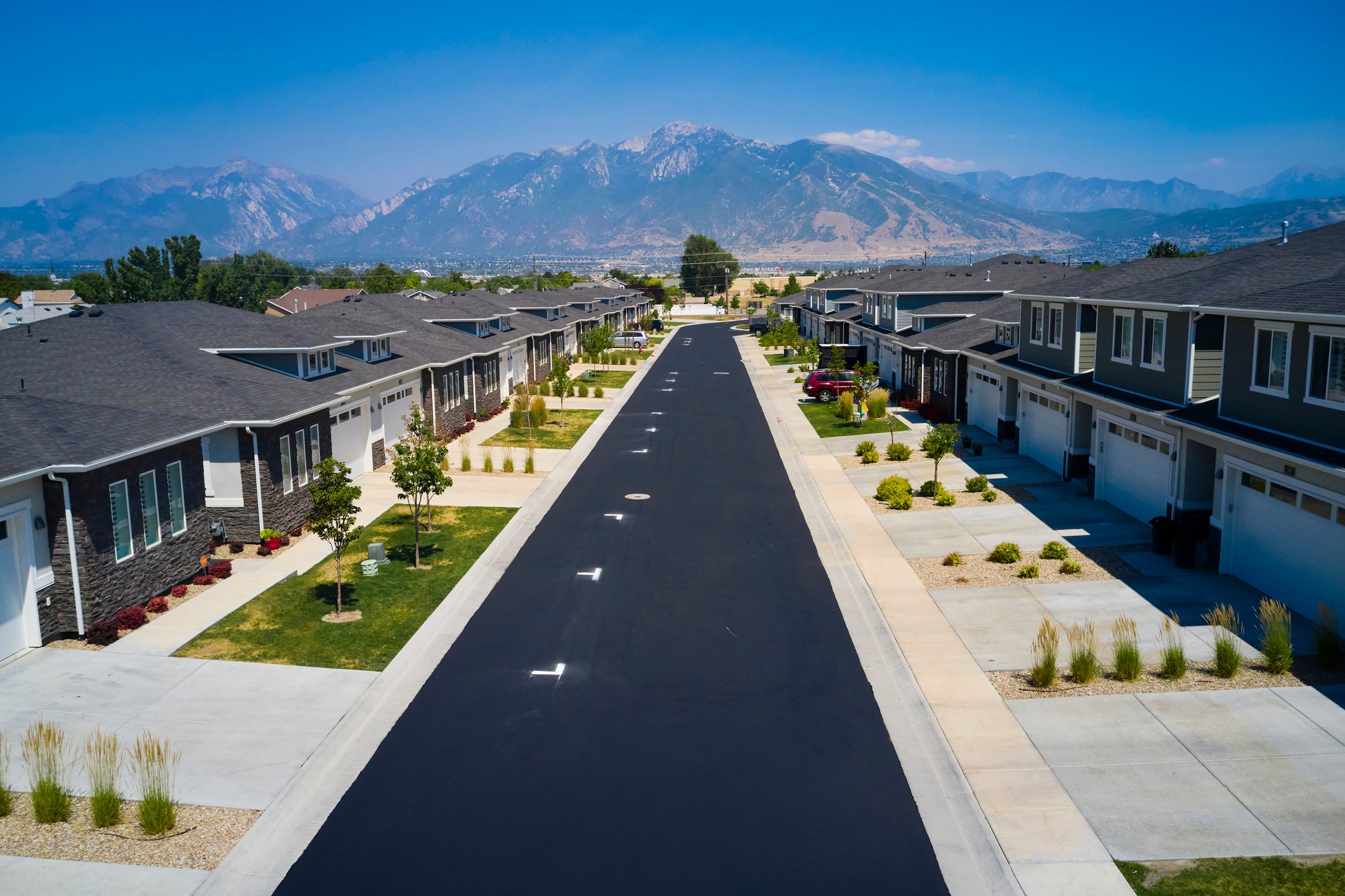 Newly developed neighborhood with mountains in background.