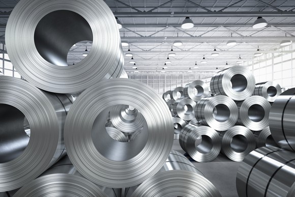 Rolls of steel in a warehouse.
