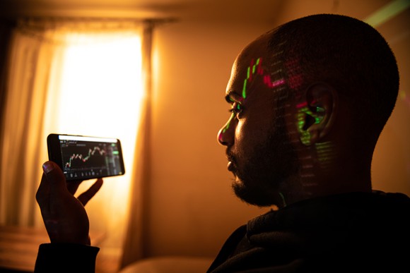 Person looking at a chart on a smartphone.