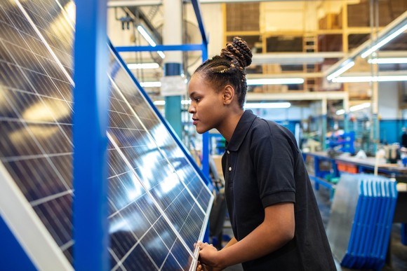 Person in factory working on solar panels.