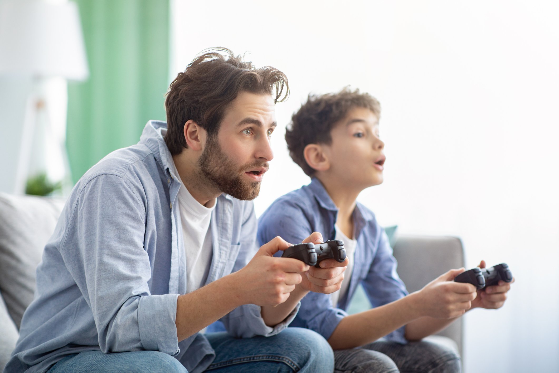 A parent playing video games with a child.