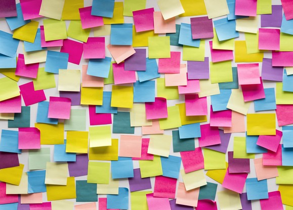 A wall filled with colorful square sticky notes.