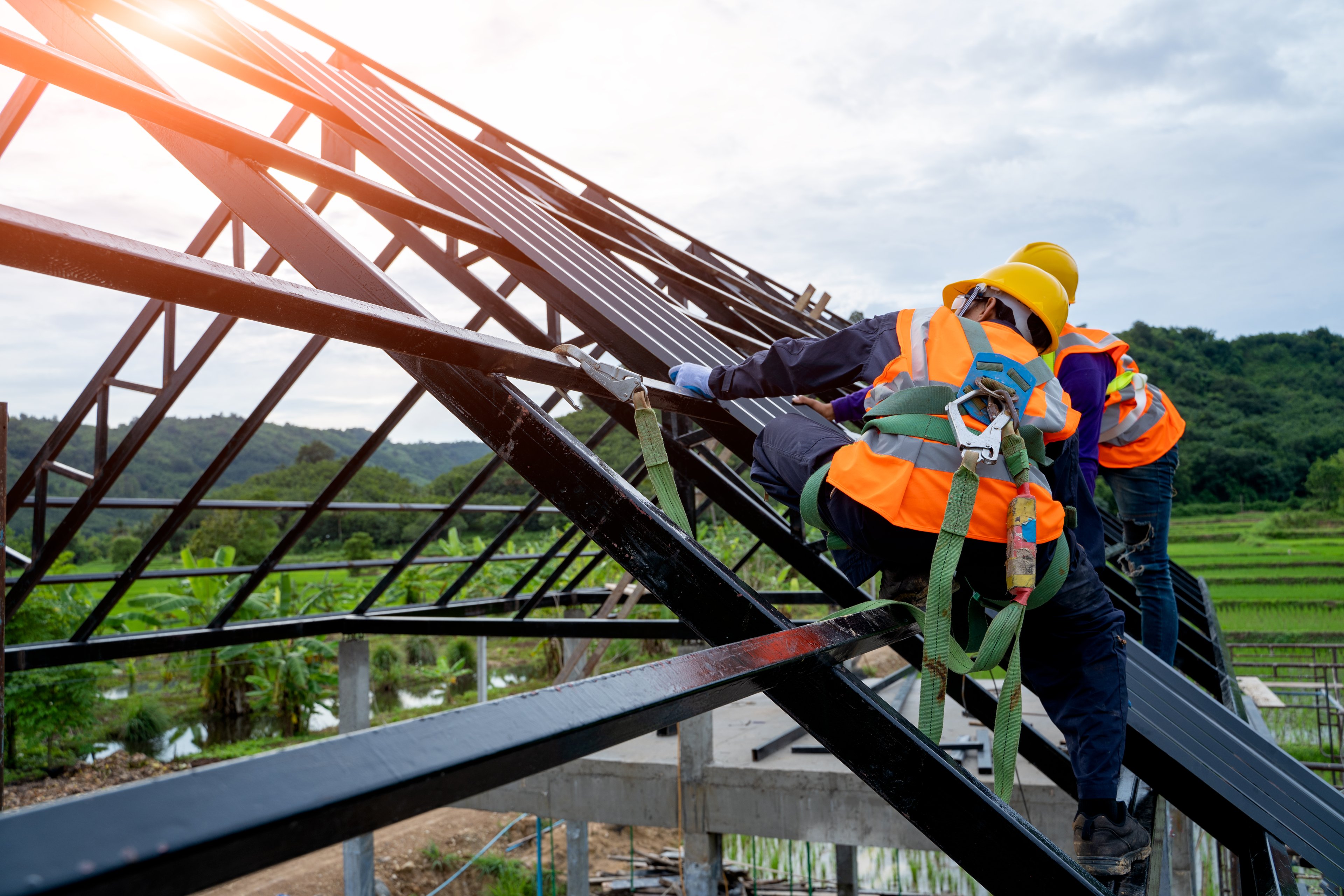 Contractors working on the frame for the roof of a new house.