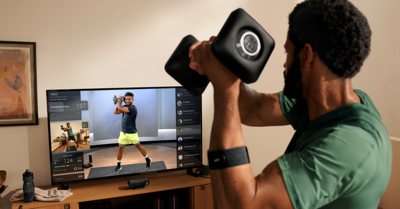 Person working out using Peloton Guide.