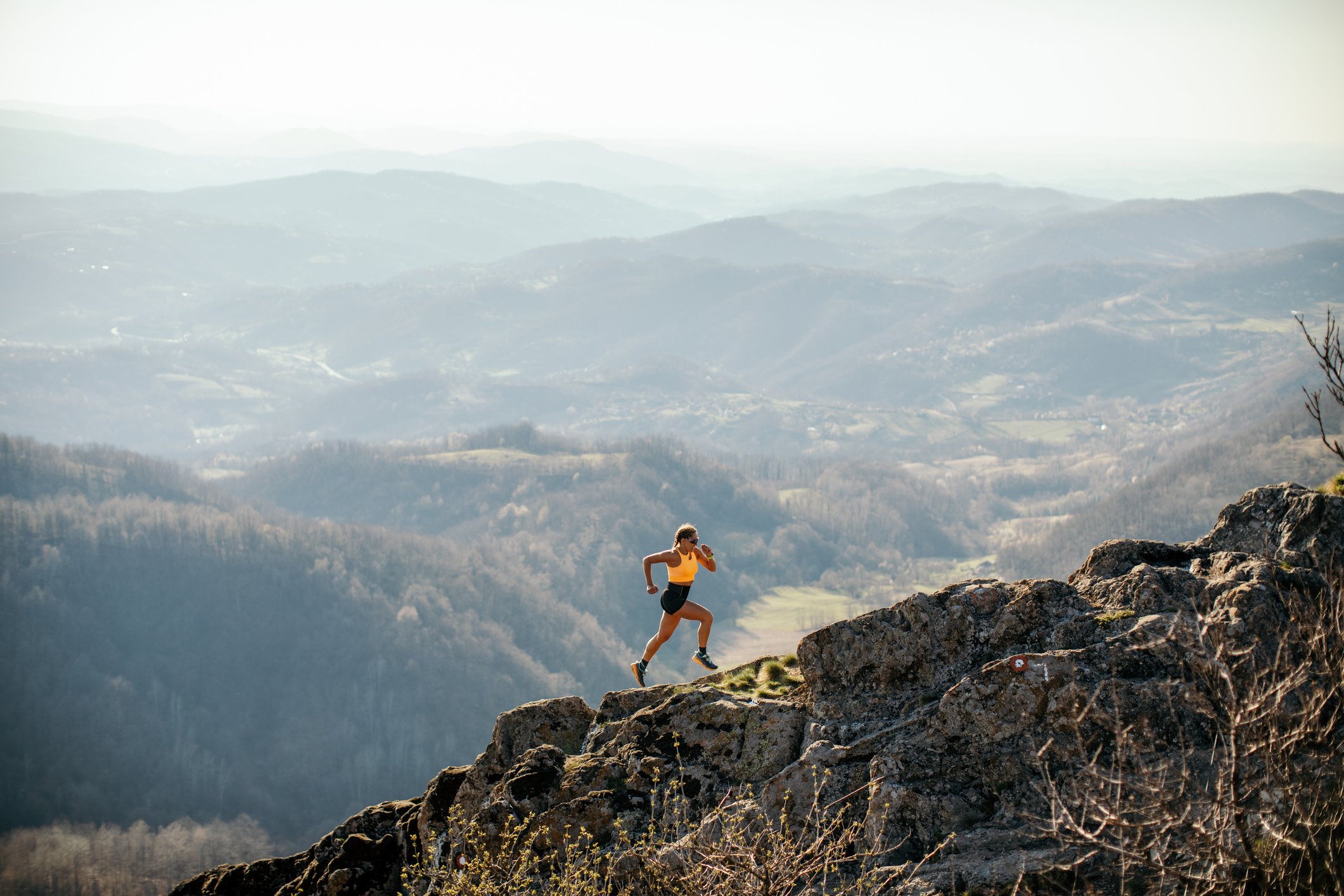 Person running up a mountain.