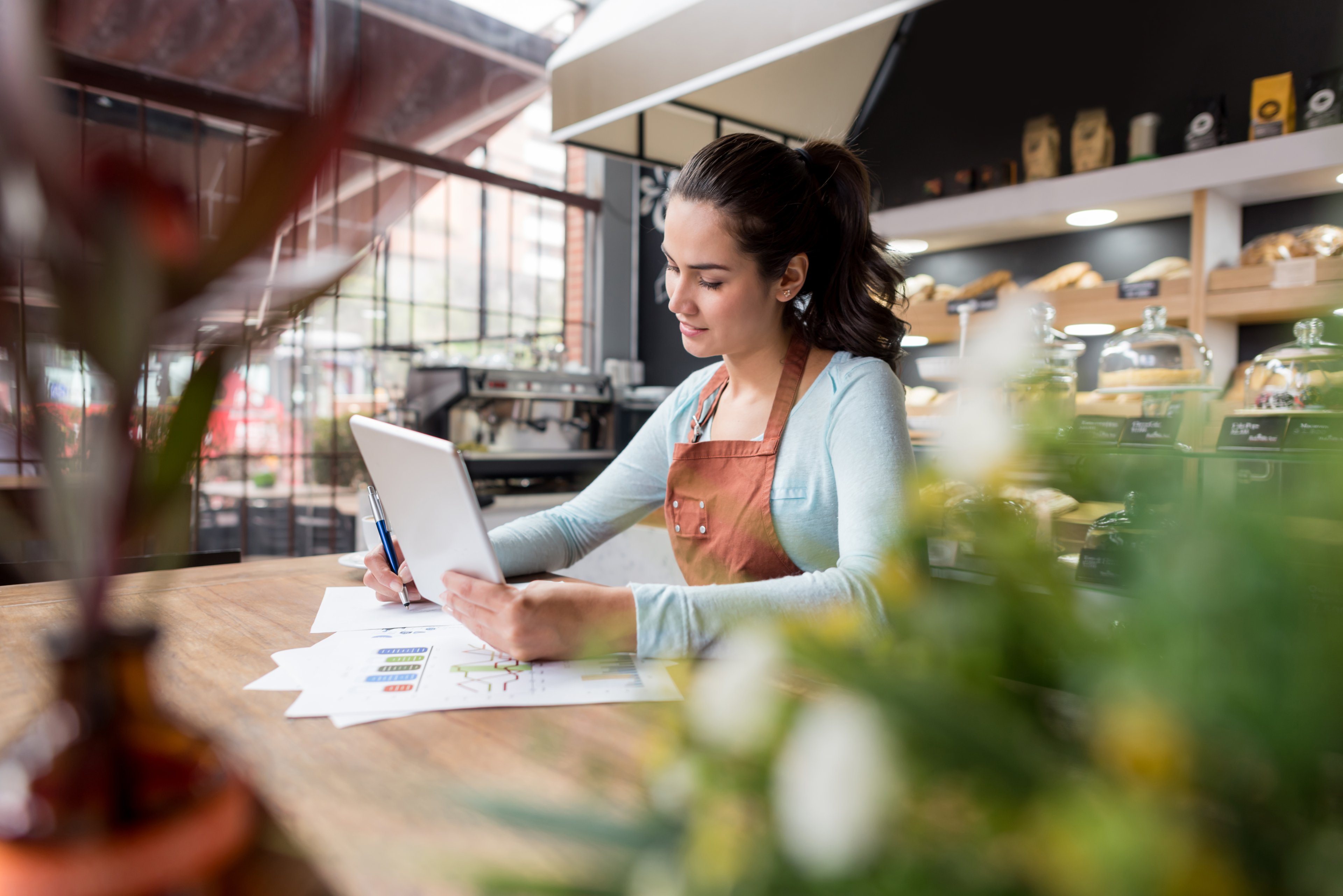 Someone in a cafe using a tablet.