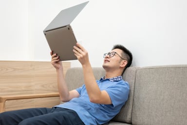 Asian man holding laptop