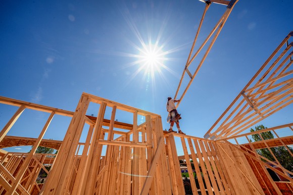 A house under construction with a worker.