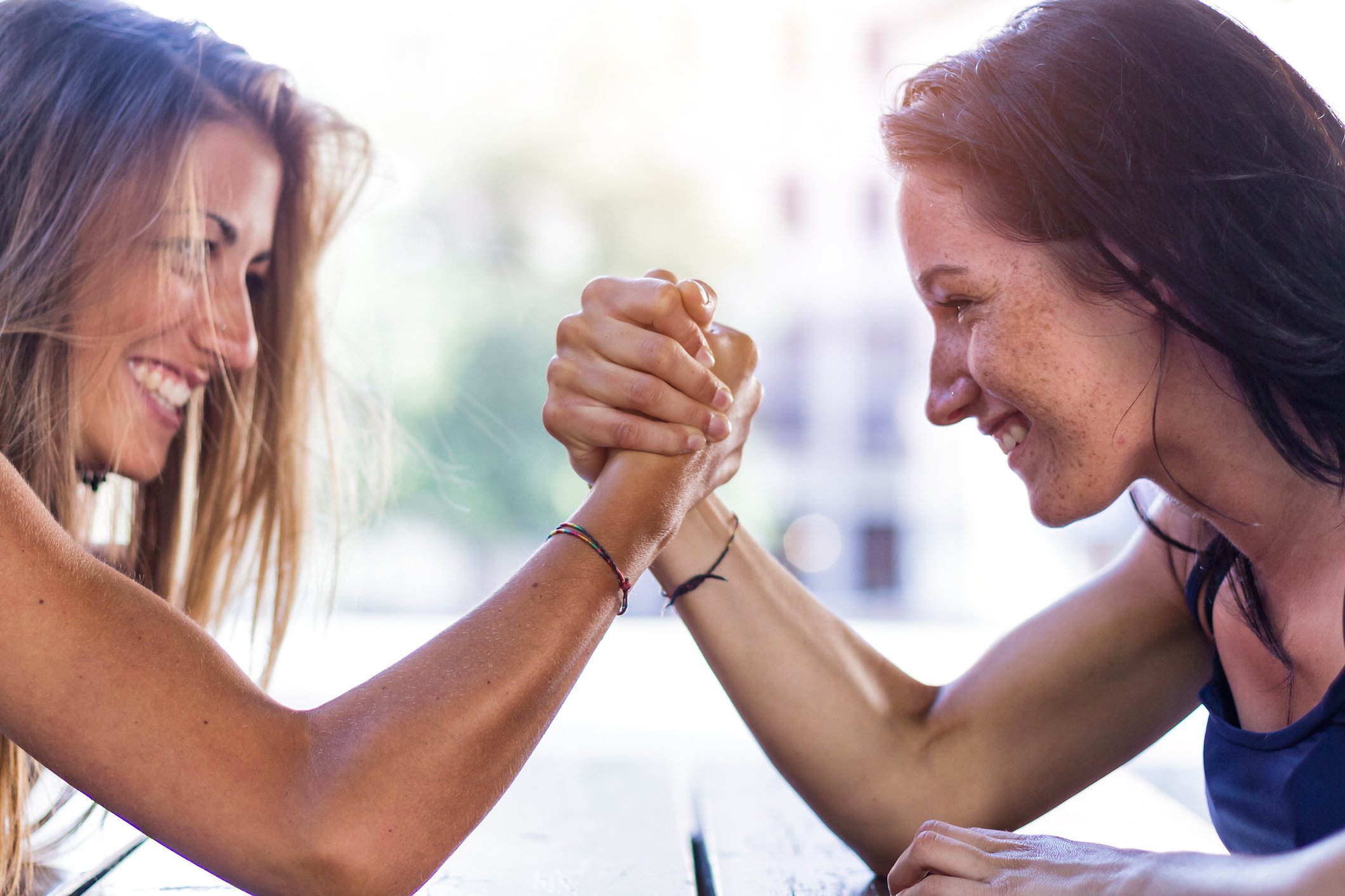 Two people having an arm wrestling match.