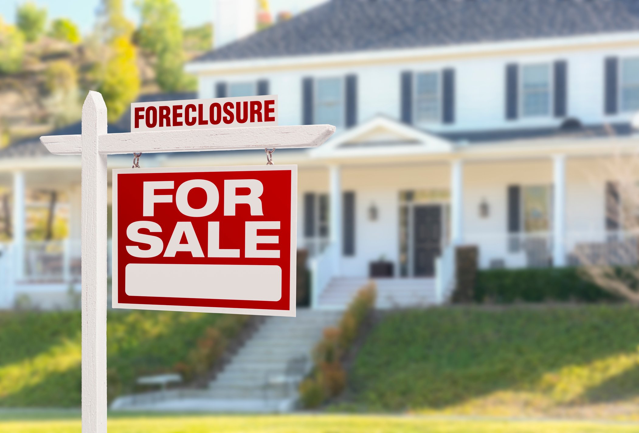 A house with a foreclosure sign in front of it