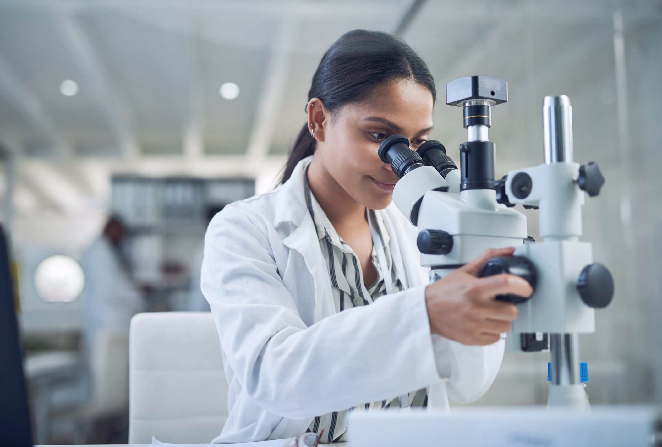 Woman using microscope in a science lab.