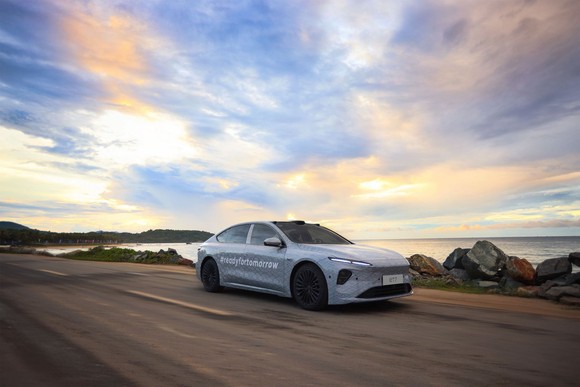 Nio ET7 sedan driving by water. 
