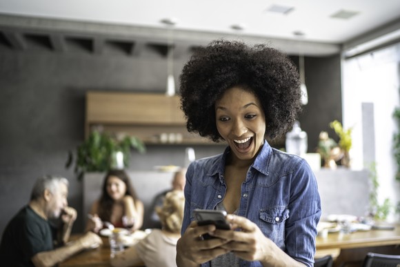 Surprised person looking at phone. 