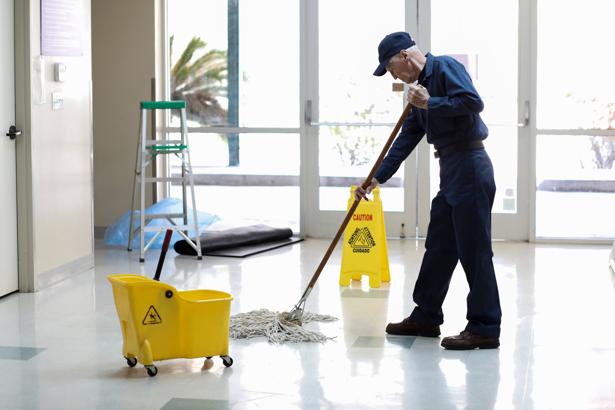 A person mopping a floor.