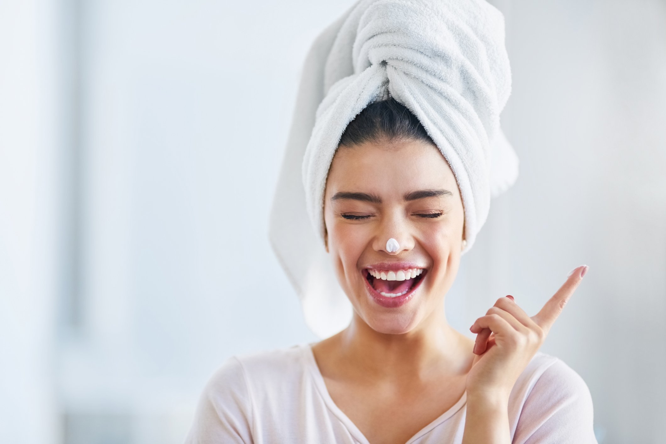 Happy person applying a skincare product.
