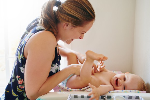 A person changing a baby's diaper.