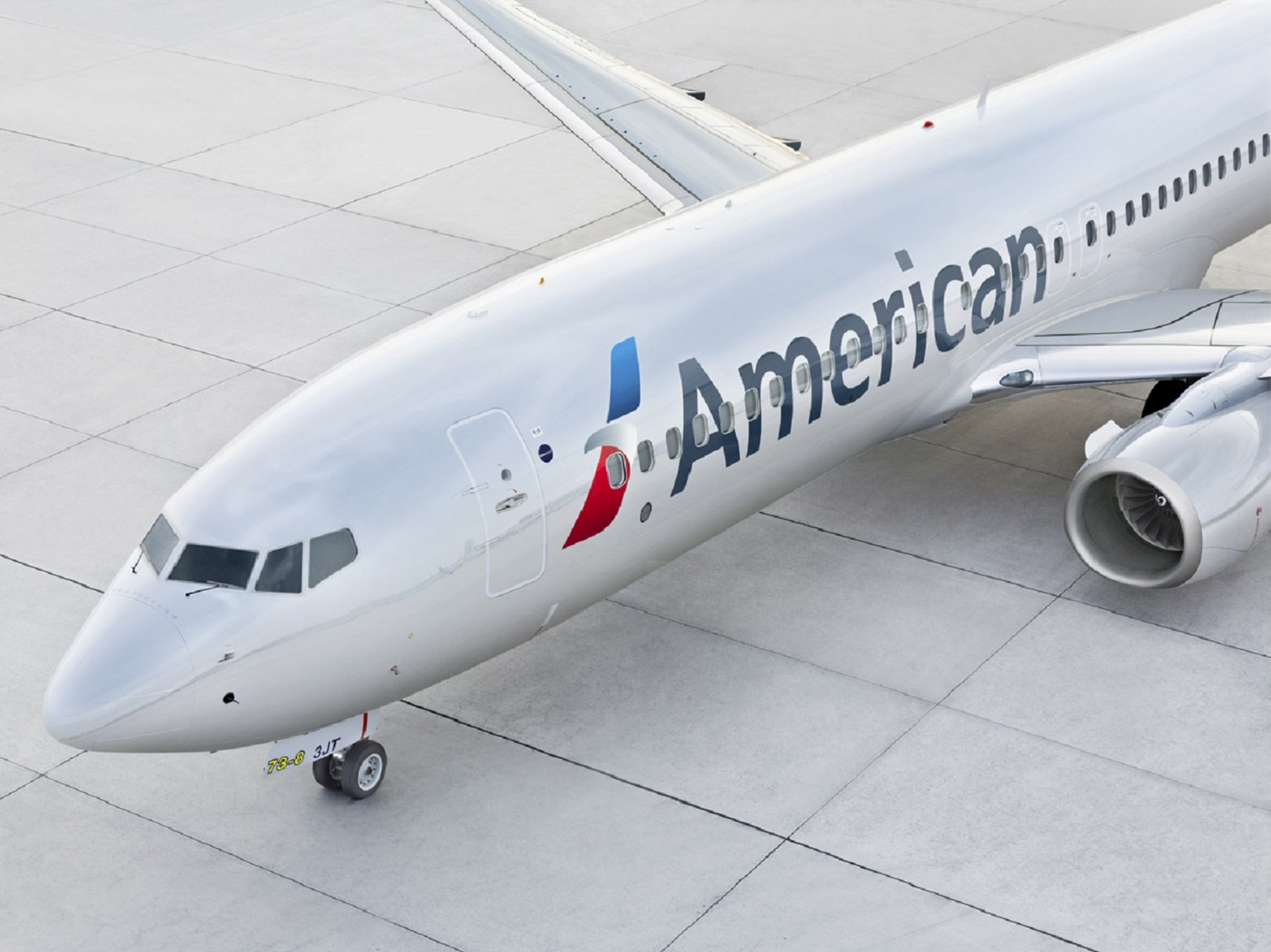 An American Airlines plane on airport tarmac. 
