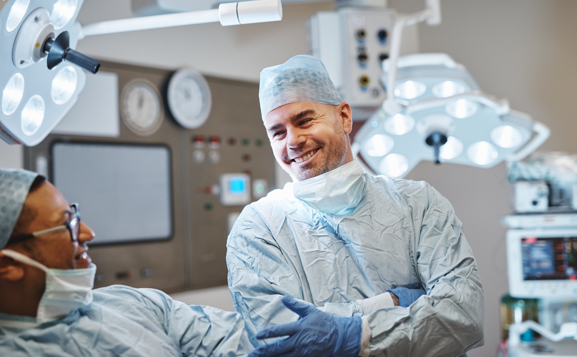 Two surgeons chat in the operating room.