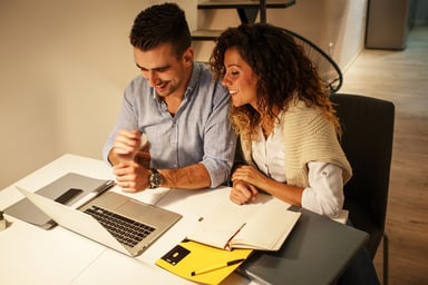 A happy couple looking at the laptop.