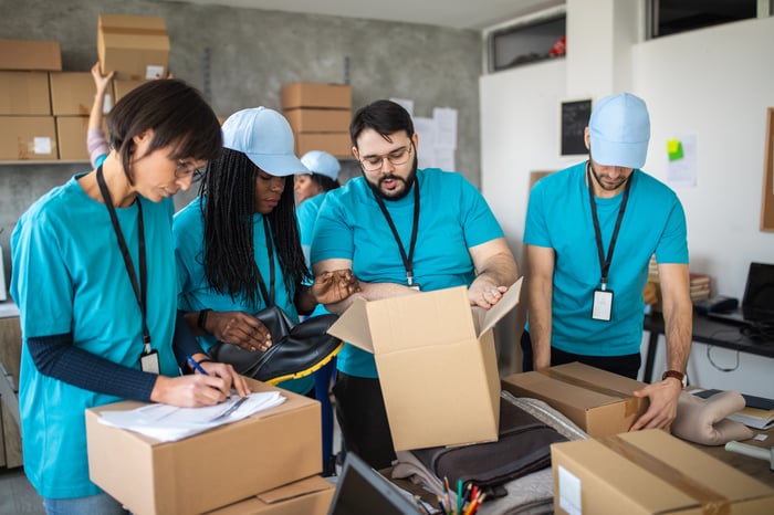 A group of people packing boxes.