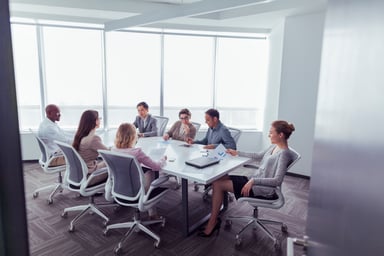 A group meets in a business conference room.