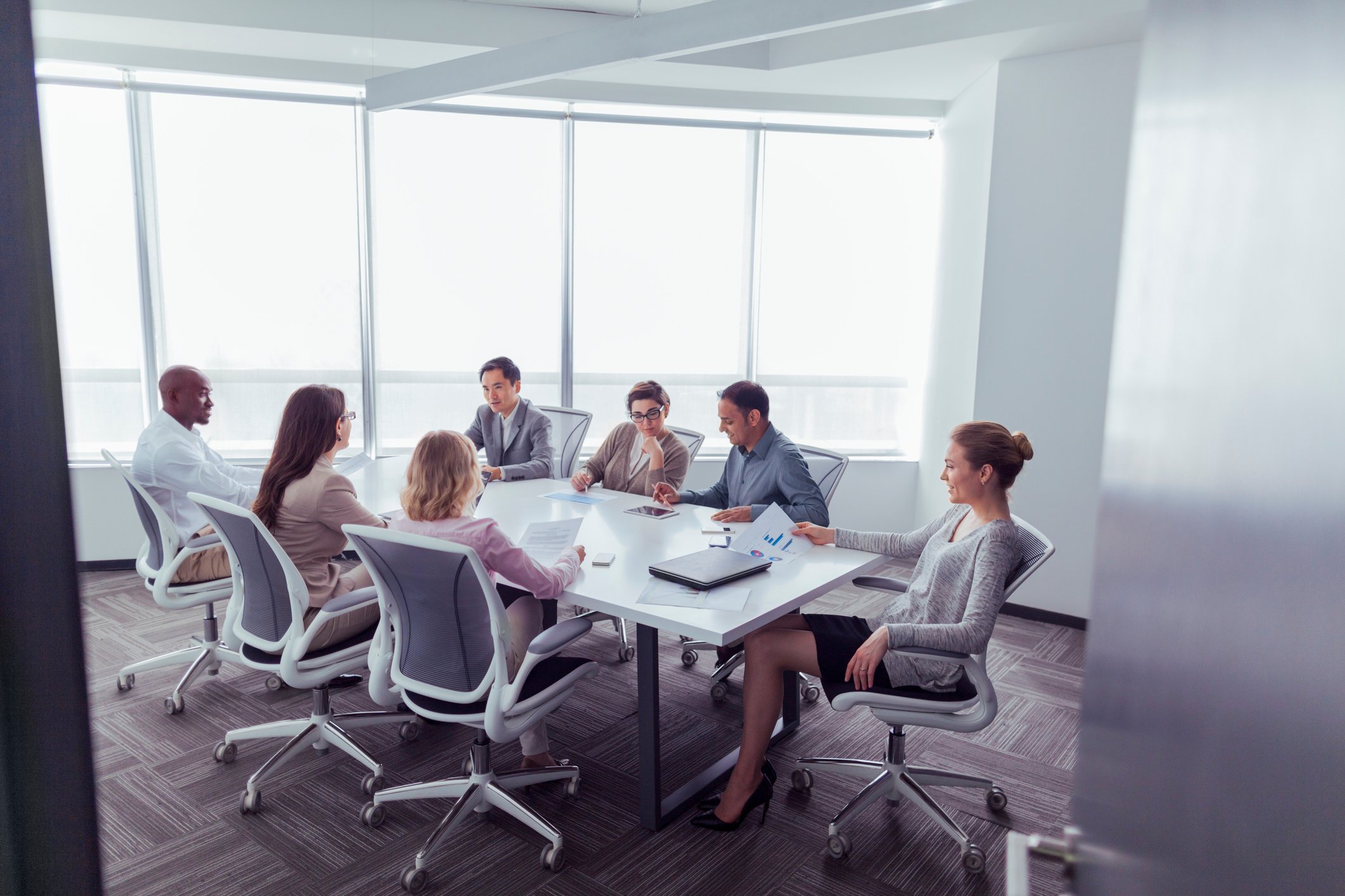 A group meets in a business conference room.