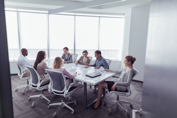 A group meets in a business conference room.