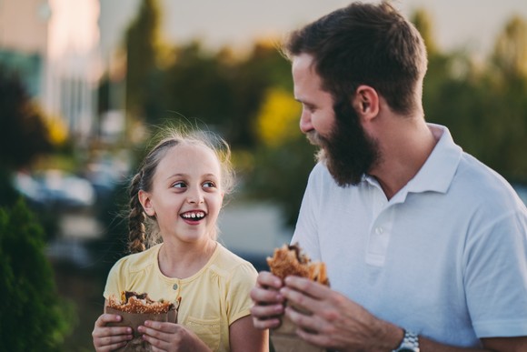 Two people eating burgers.