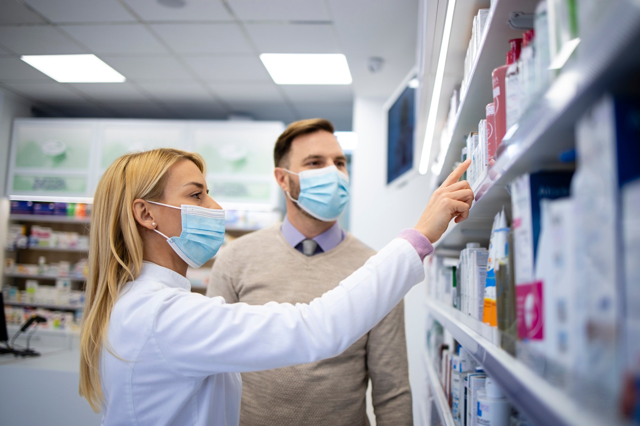 A pharmacist consults with a customer.