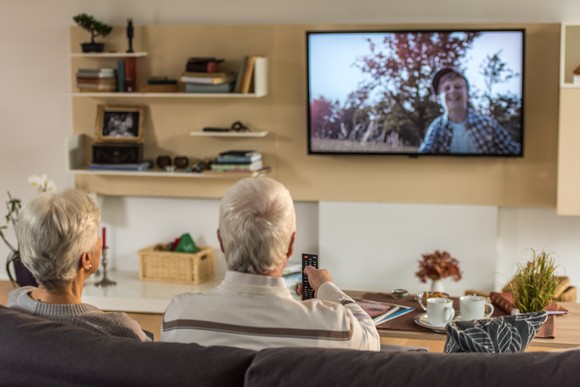 Two people watching television.