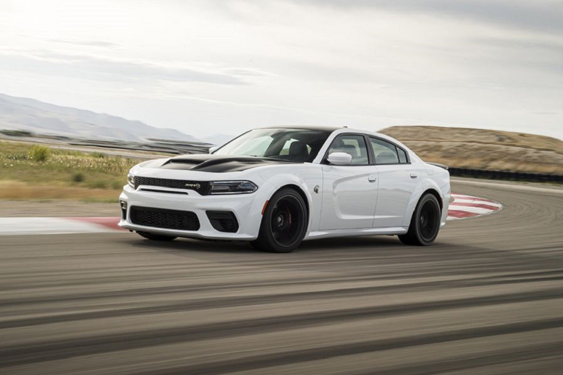 A 2021 Dodge Charger Hellcat SRT Redeye doing laps on a race on a race track.