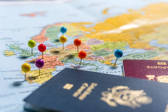 Passports on map with pins in European cities.