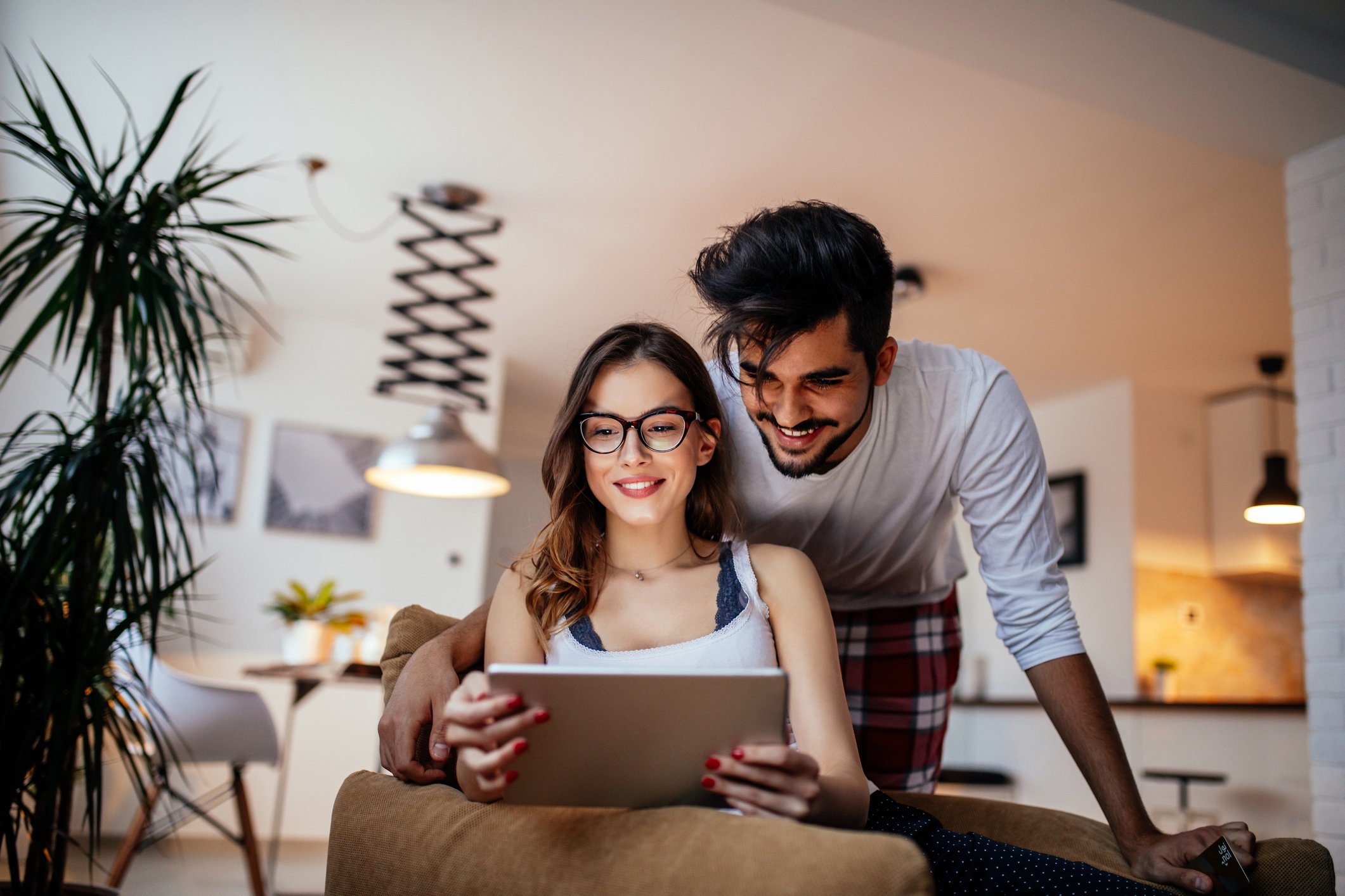 Two people researching on laptop.