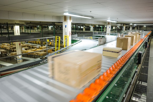 Ecommerce warehouse with packages moving on high speed conveyor.