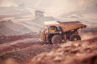 A large truck in a copper mine.
